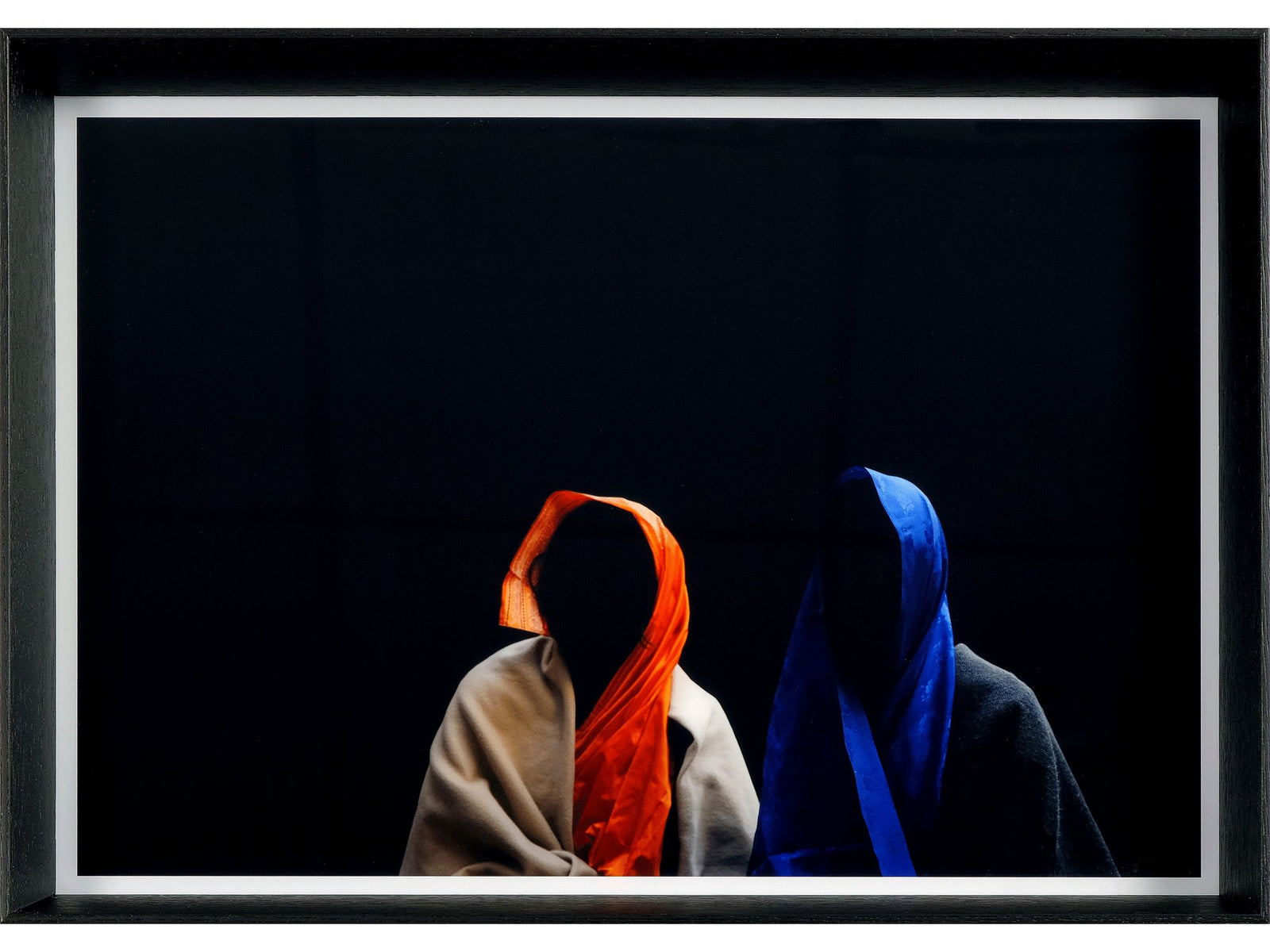 Fine art photography by André Wagner: Two covered upper bodies appear against black — Black hole 2.