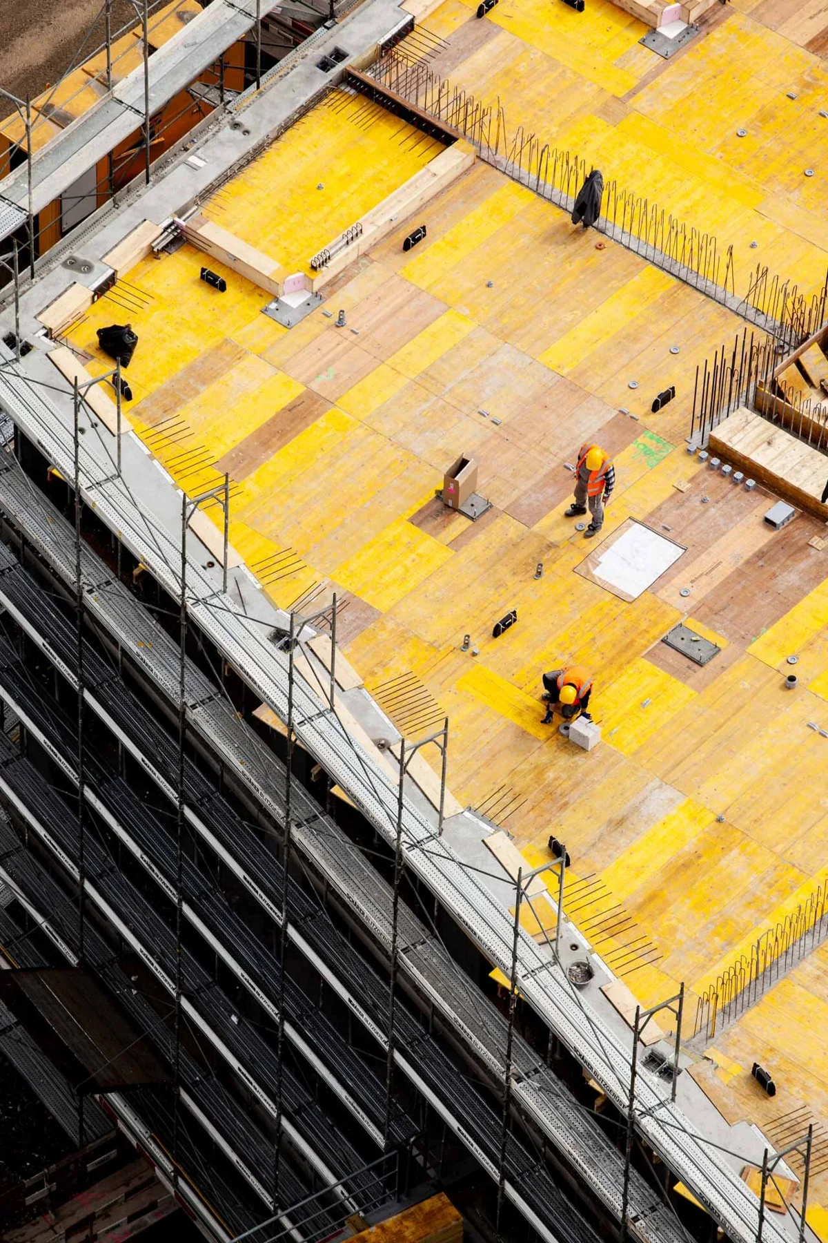 Vue plongeante sur des panneaux de coffrage jaunes sur un chantier