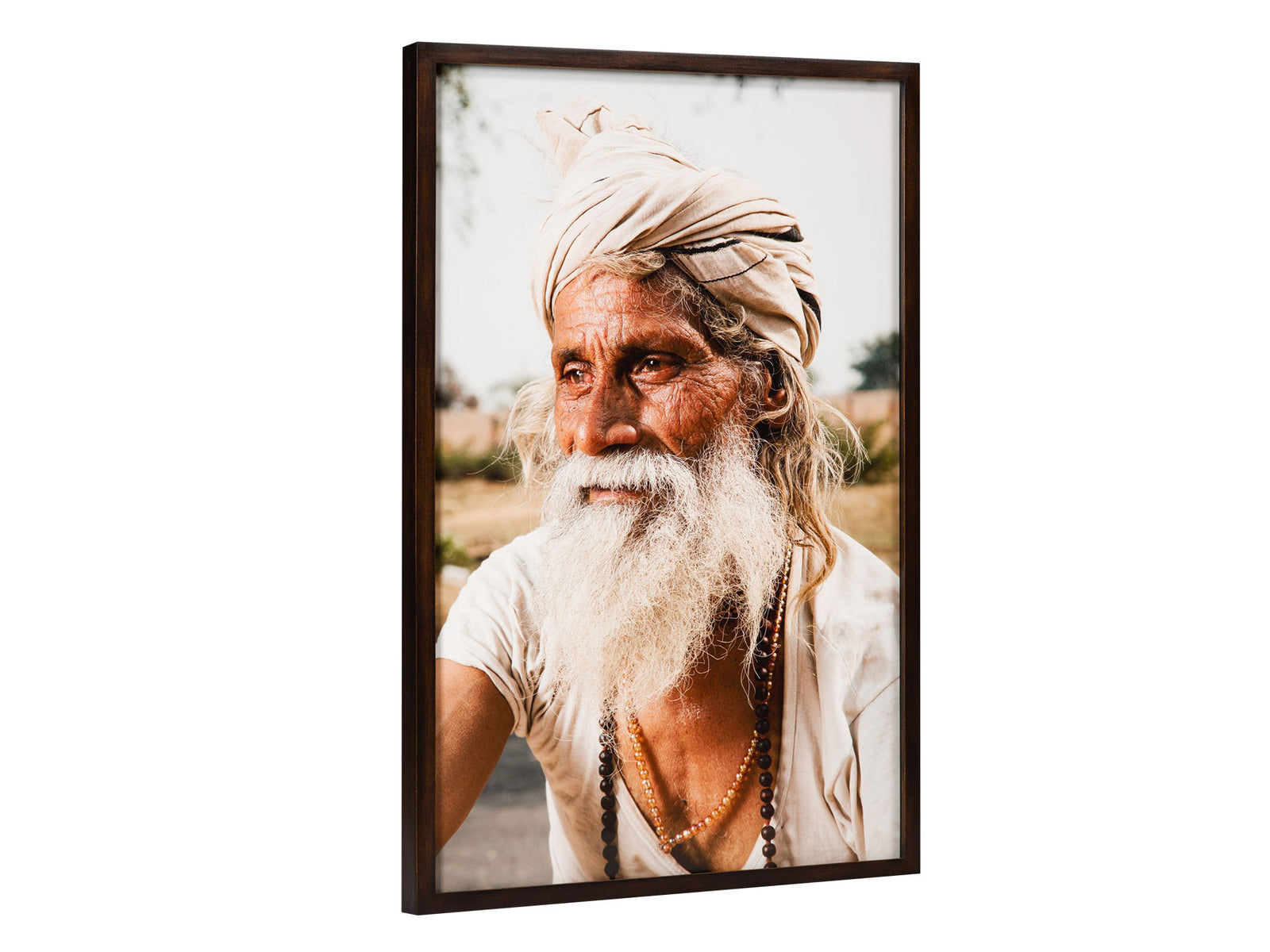 Fine art photography by André Wagner: The tight portrait shows an older man with a white beard and pale wrapped headcloth — Dandavat parikram sadhu, Indien.