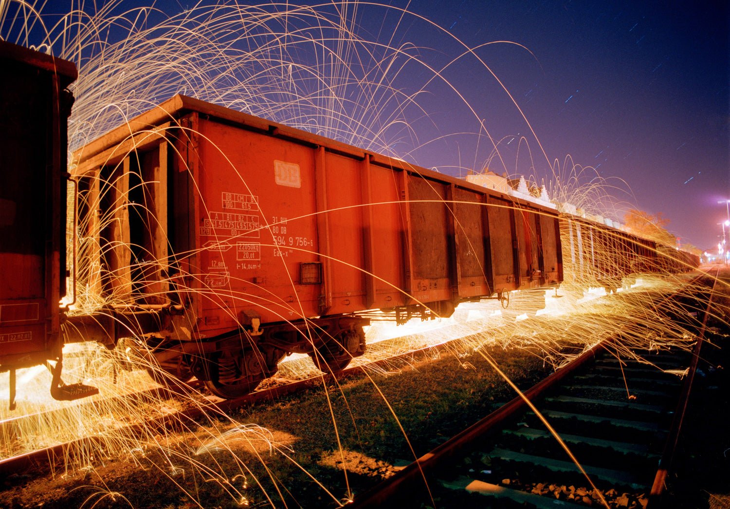 Fine art photography by Andr&eacute; Wagner: A red freight wagon recedes diagonally &mdash; Express, Deutschland.