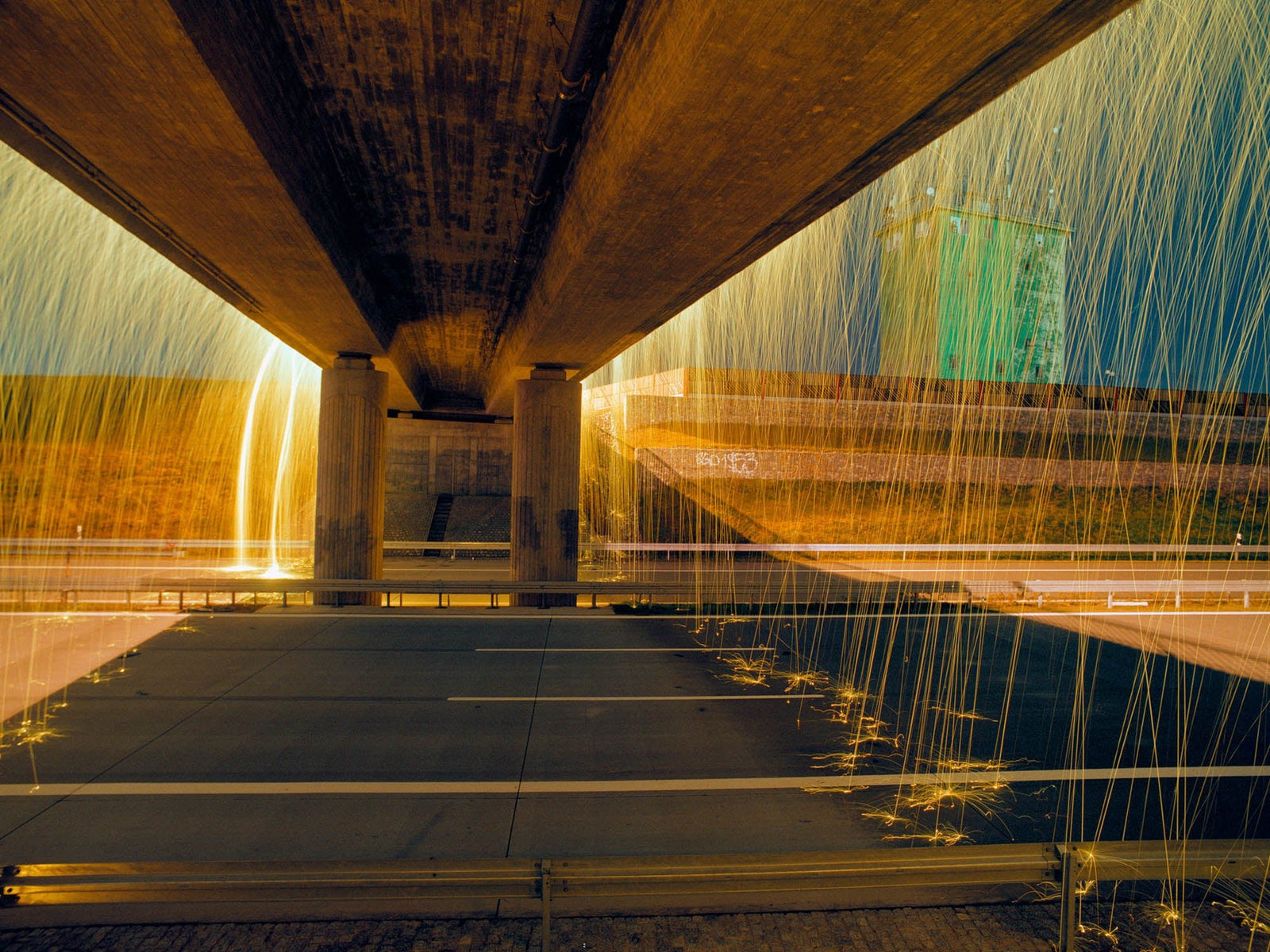 Fine art photography by André Wagner: The underside of a bridge leads strictly towards the centre — Golden bridge 1, Deutschland.