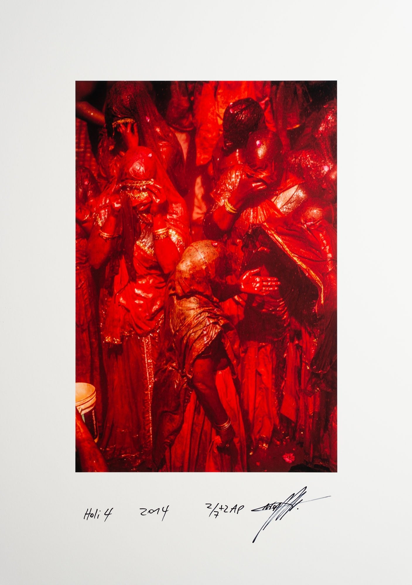 Fine art photography by André Wagner: A close group appears in deep red — Holi 4, Indien.