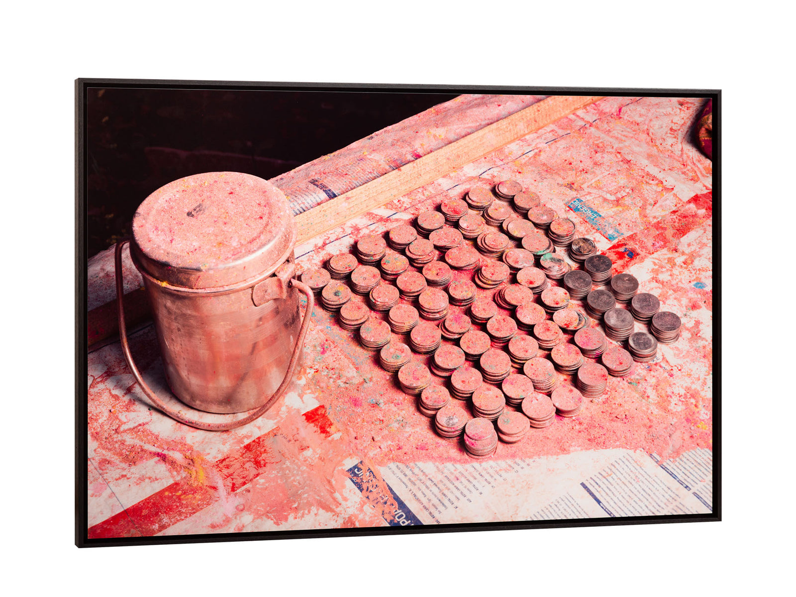 Fine art photography by André Wagner: Rows of coins lie on a surface covered in pink powder — Holi money, Indien.