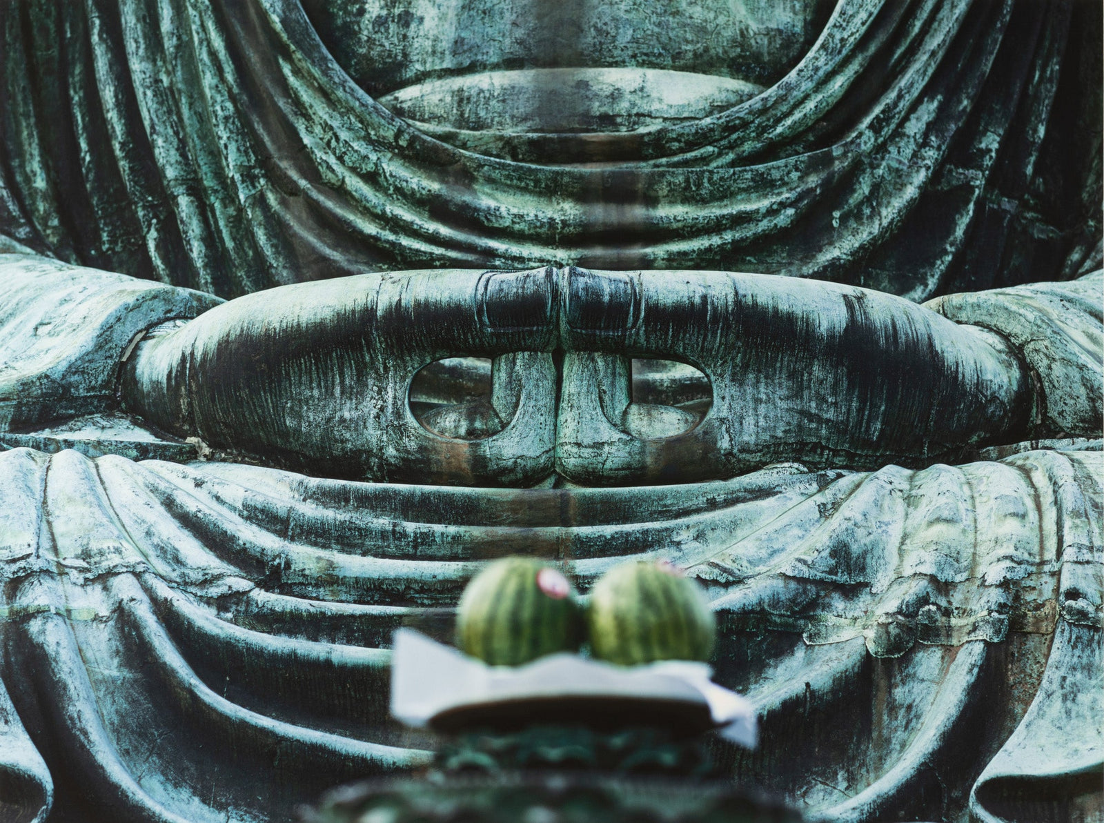 Fine art photography by André Wagner: The crop shows overlapping hands of a large seated figure — Kötoku-in, Japan.