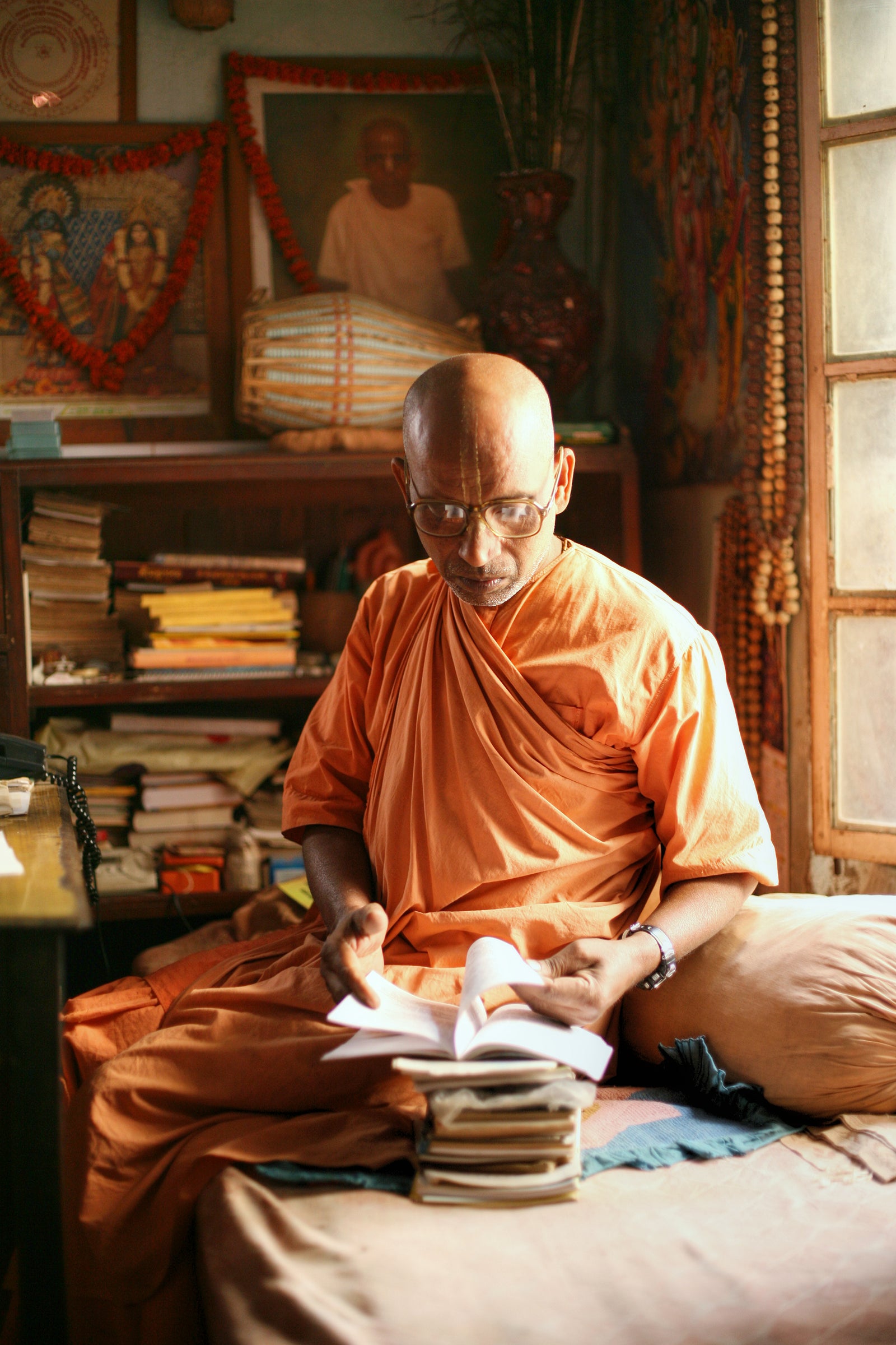 Fine art photography by André Wagner: Monk reading Vedic texts, Mayapur, West Bengal.