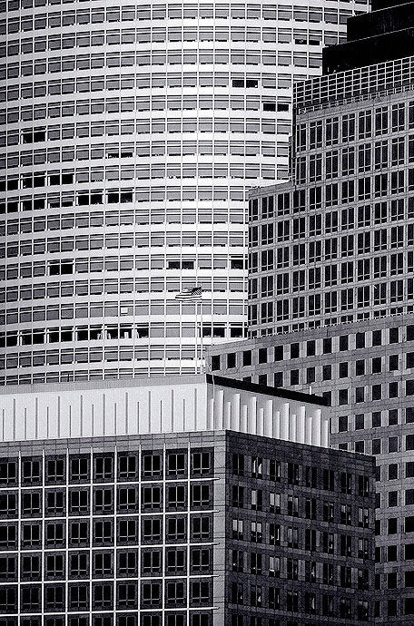 Fine art photography by André Wagner: Overlapping high-rise facades fill a black-and-white frame — New York Silver Edition 2, USA.