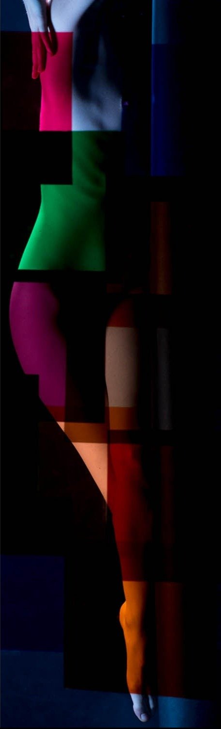 Fine art photography by André Wagner: An extremely narrow vertical frame shows portions of a human body against black — Paula viii, Studio.