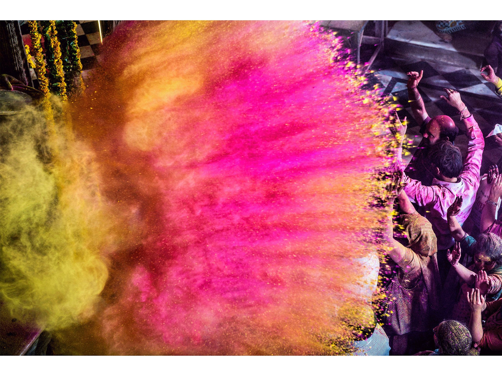 Fine art photography by André Wagner: A large cloud of yellow, orange and pink pigment crosses the picture — Radha raman ecstasy, Indien.