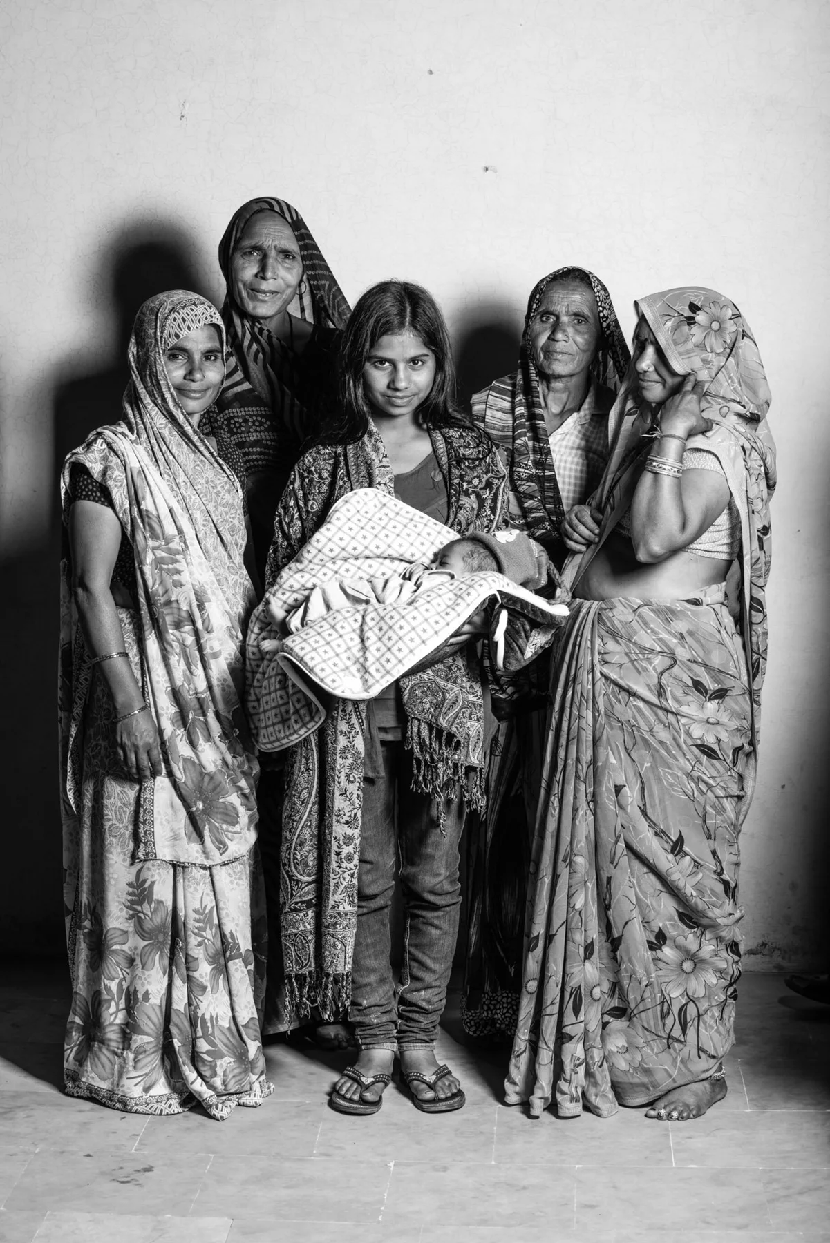 Black and white group portrait of women with a baby held.