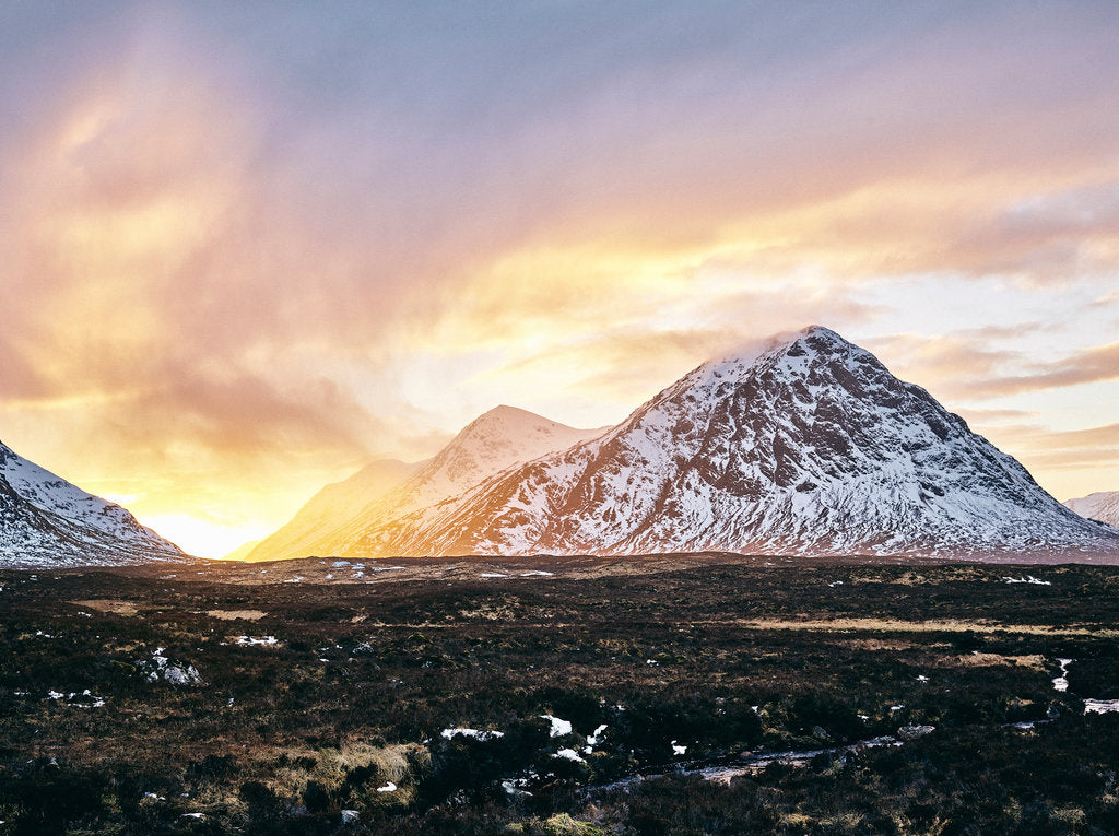 Fine art photography by André Wagner: A snowy mountain rises right of centre above a dark open plain — Scottish Highlands 1, Schottland.