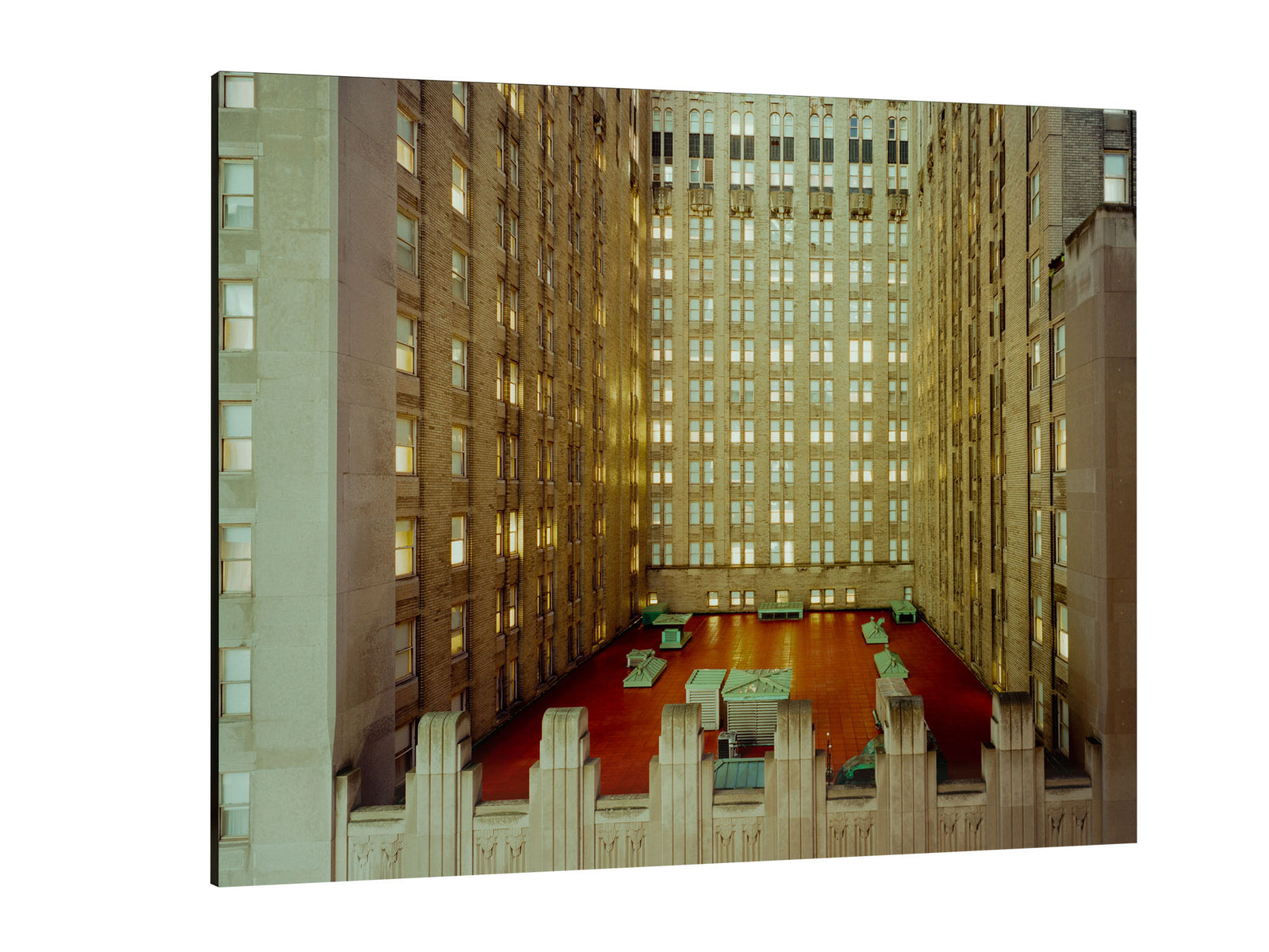 Fine art photography by André Wagner: A lower rooftop with strong red elements sits between high facades — Sex affairs, Usa.