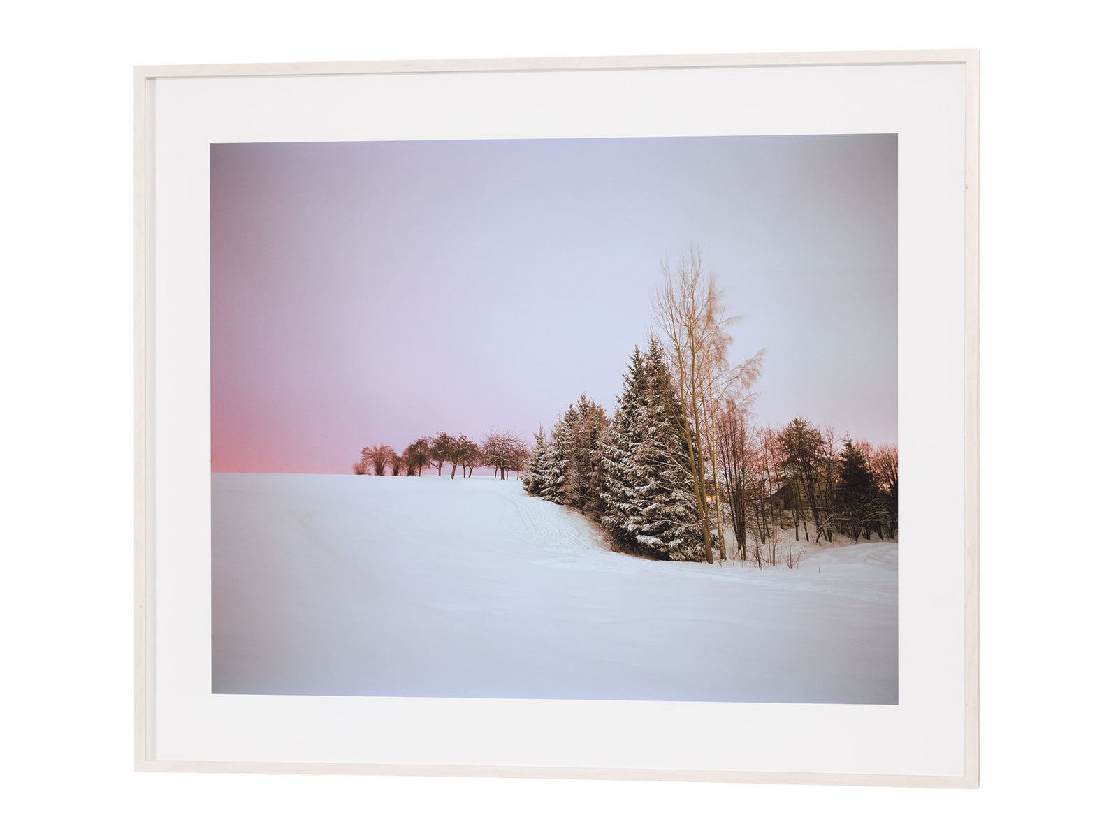 Fine art photography by André Wagner: A snowfield rises gently towards a group of trees — Ski hill, Deutschland.