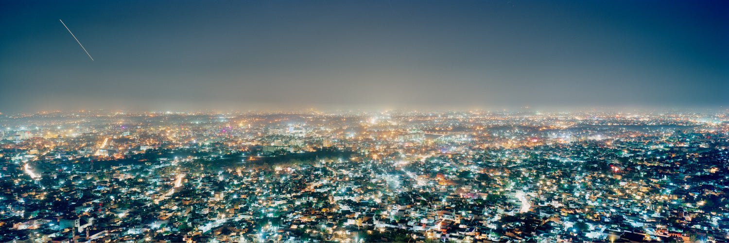 Fine art photography by André Wagner: Countless lights spread across a long panorama — Skyline of Jaipur, Indien.