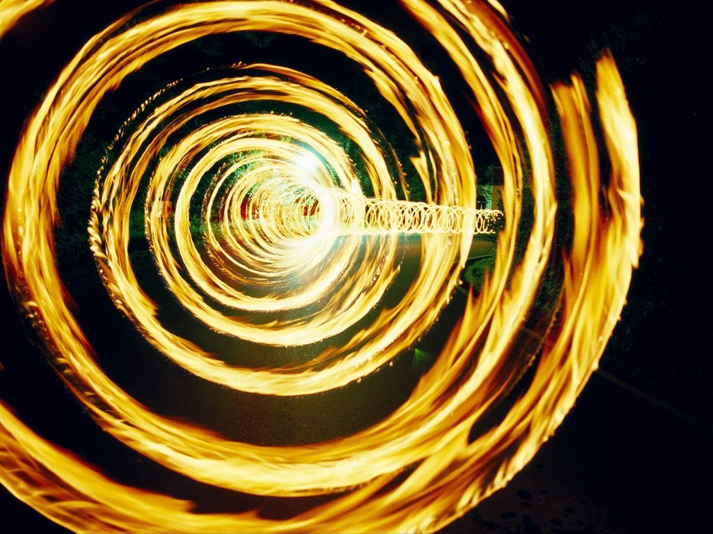 Fine art photography by André Wagner: Golden rings of light fill the picture, narrowing towards a bright centre slightly left of the middle — Spirale, Deutschland.
