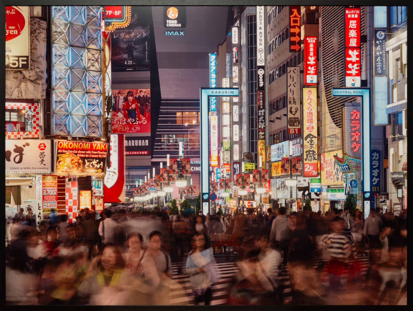 Fine art photography by André Wagner: A narrow brightly signed street recedes between tall façades — Tokyo shinjuko 5, Japan.