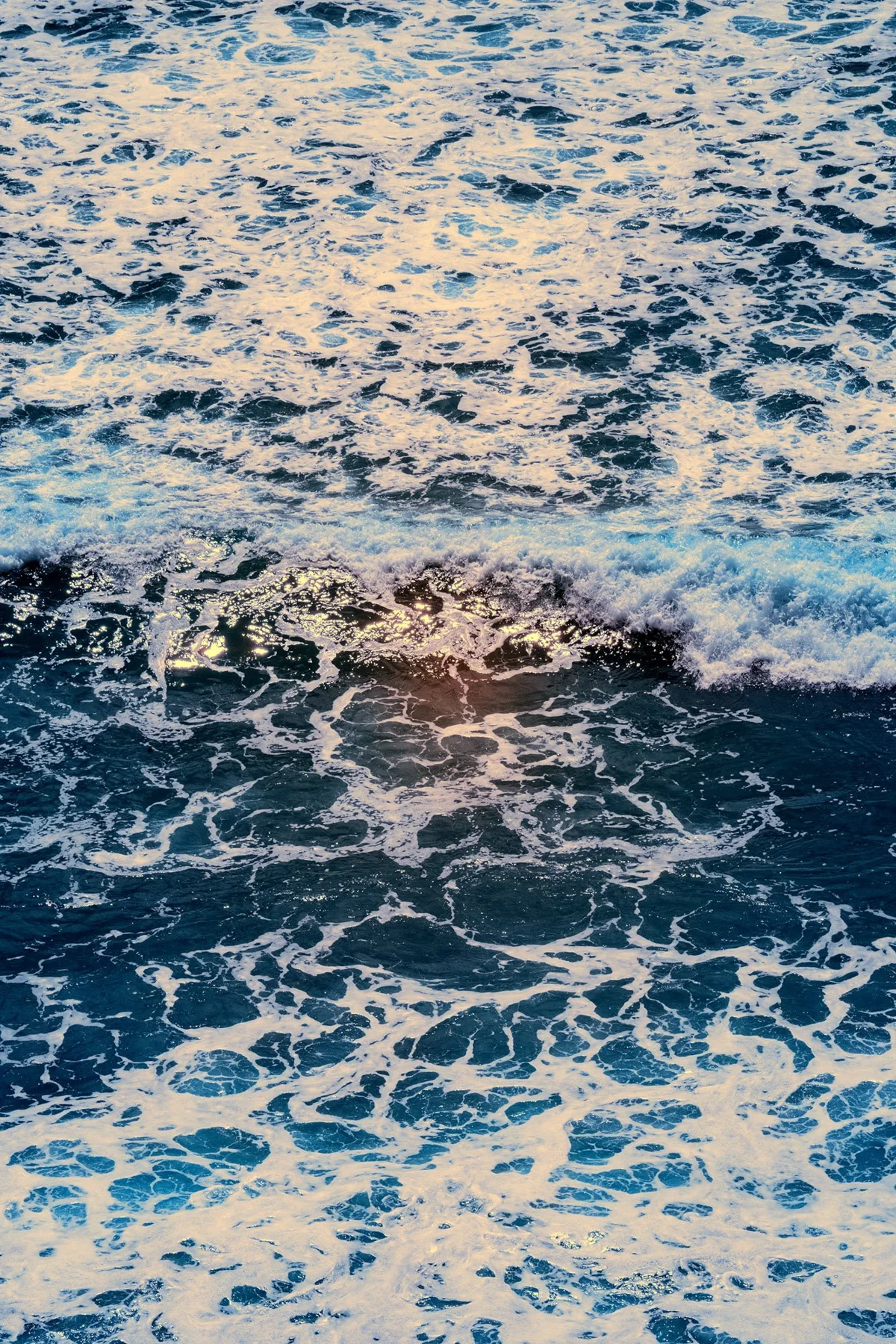 Sea surf with white foam patterns.