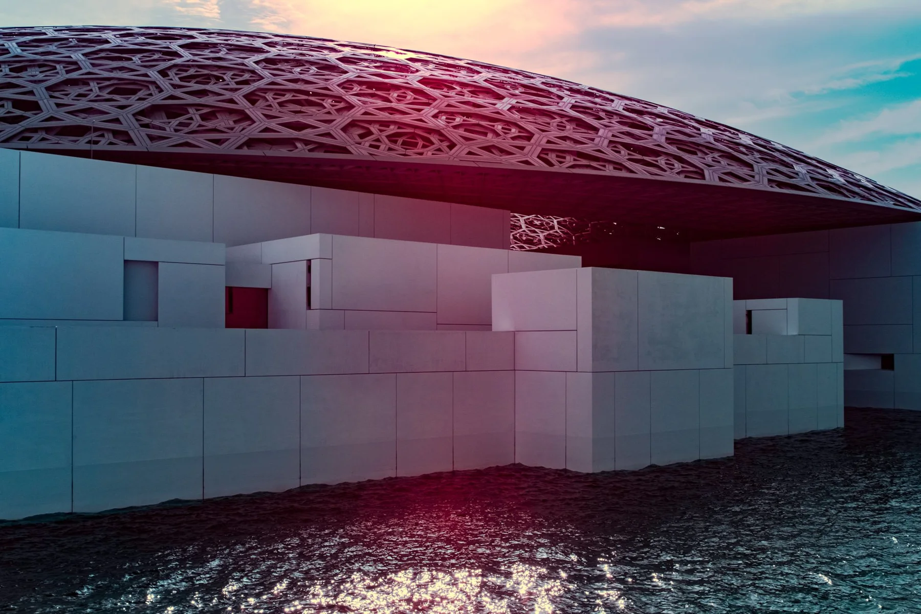 Opened domed roof over white buildings on the water.